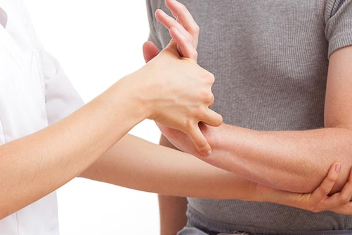 A man is putting his hand on a woman's arm.