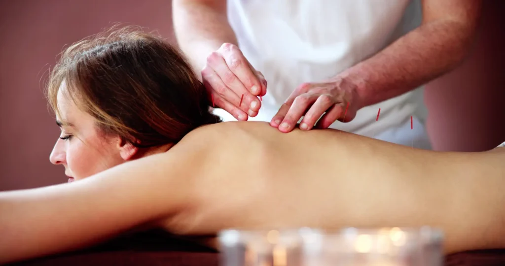 A woman getting a back massage at a spa.